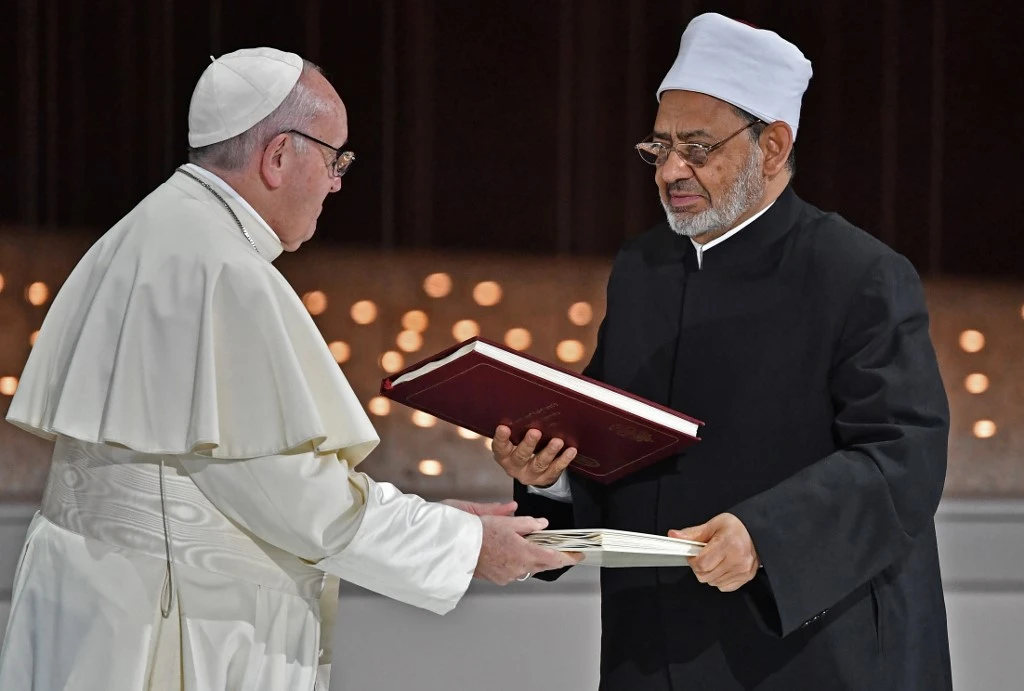Pope Francis and Egypt’s Azhar Grand Imam Sheikh Ahmed Al-Tayeb exchange documents after signing them during the Human Fraternity Meeting last February 4, 2019. (AFP)