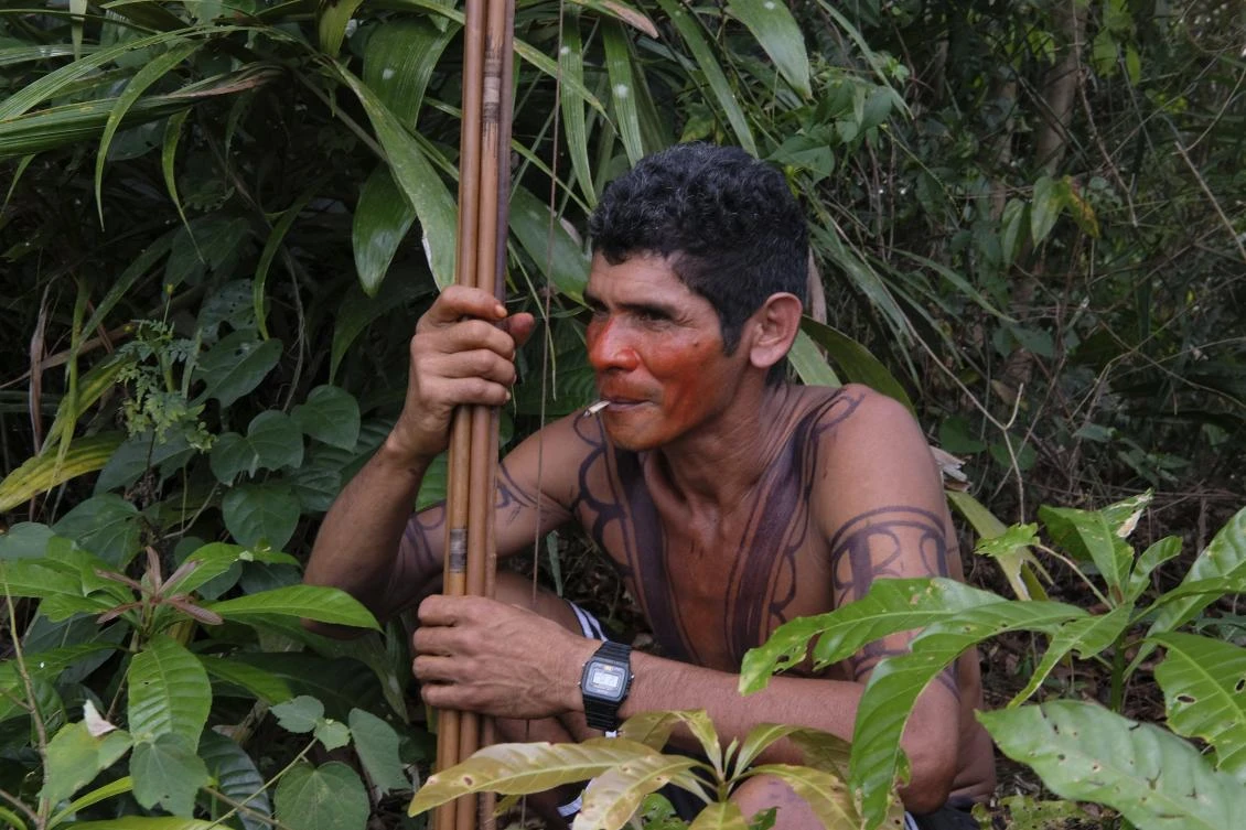 Luiz Tembe, an indigenous Tembe warrior, smokes a cigarette as he waits for police to arrive with other members of his tribe on the Alto Rio Guama indigenous reserve in Para state, Brazil, Wednesday, Sept. 4, 2019. (AP)