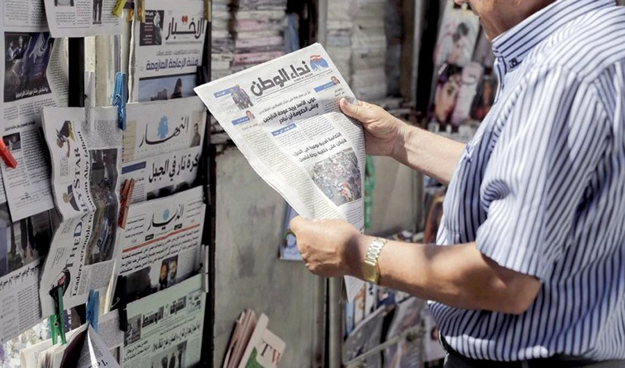 A man reads the headlines of the first issue of Nida Al-Watan, a daily newspaper published in Lebanon. (AFP)