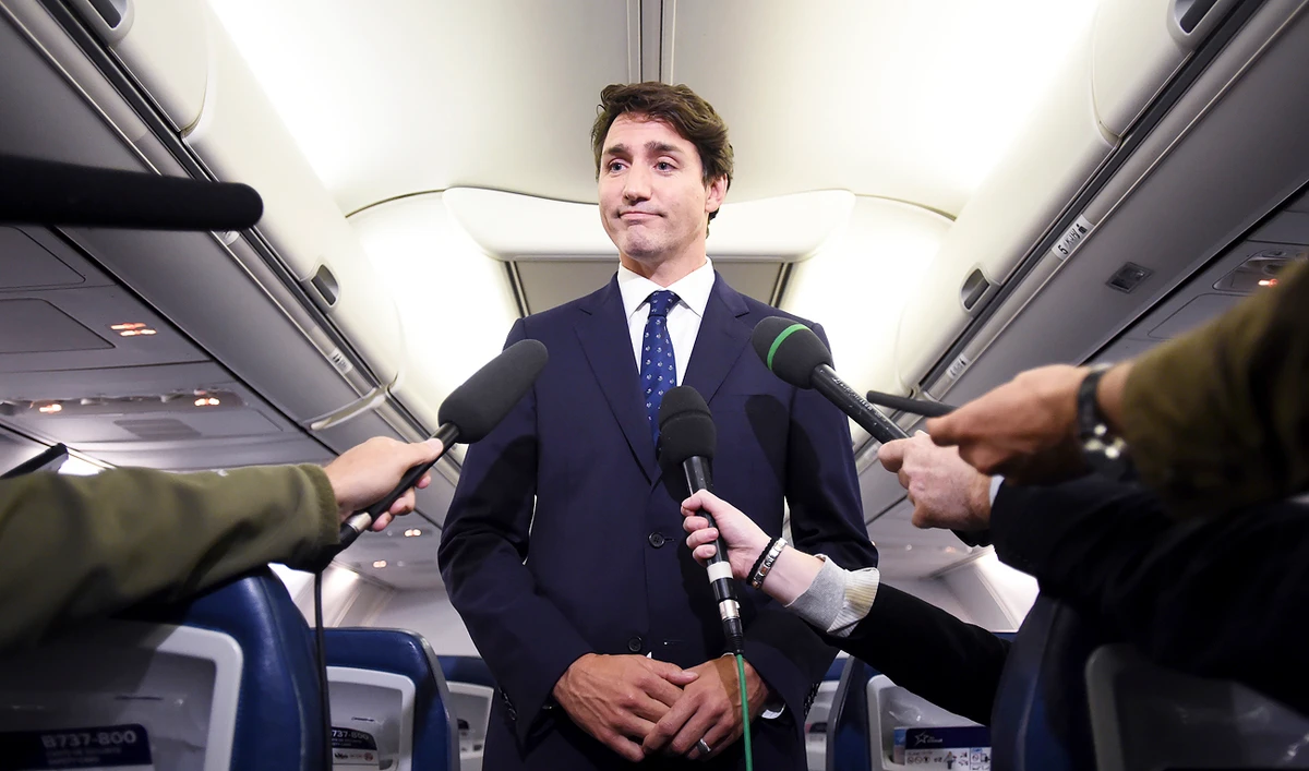 Canadian Prime Minister and Liberal Party leader Justin Trudeau makes a statement in regards to a photo coming to light of himself from 2001, wearing "brownface," during a scrum on his campaign plane in Halifax, Nova Scotia, Wednesday, Sept. 18, 2019. (Sean Kilpatrick/The Canadian Press via AP)