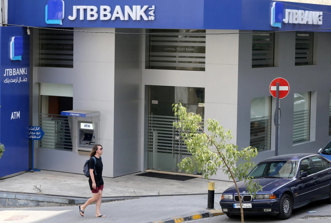 A pedestrian walks past Jammal Trust Bank (JTB) branch in Ashrafieh, Lebanon, August 30, 2019. (Reuters)