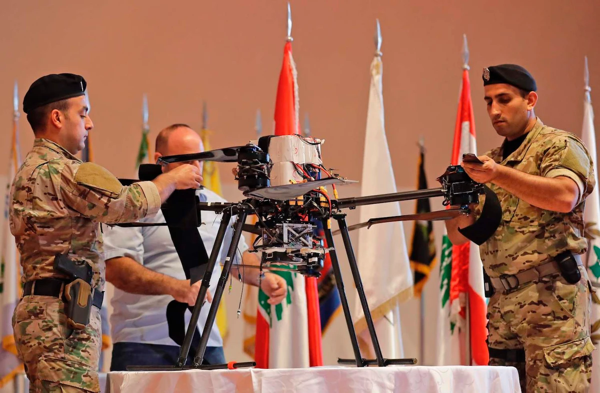 Lebanese forces soldiers display an Israeli drone that was captured after falling in a southern Beirut suburb on September 19, 2019. (AFP)