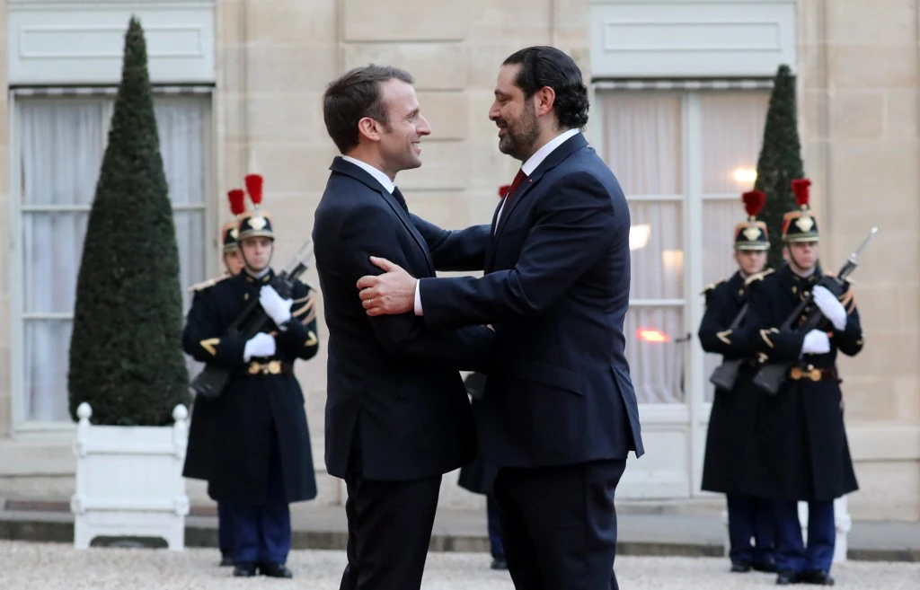 French President Emmanuel Macron, left, greets Lebanese Prime Minister Saad Hariri during their earlier meeting on April 10, 2018. (AFP)