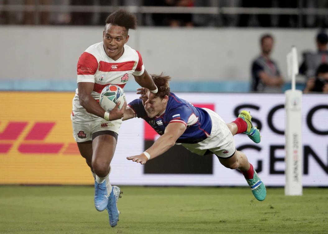 Japan’s Kotaro Matsushima, left, fends off Russia’s Vladislav Sozonov to score his third try during the Rugby World Cup Pool A game at Tokyo Stadium. (AP Photo)