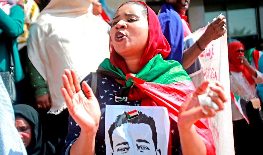 A Sudanese protester draped in her country’s national flag chants slogans during a protest in the capital Khartoum. (AFP)