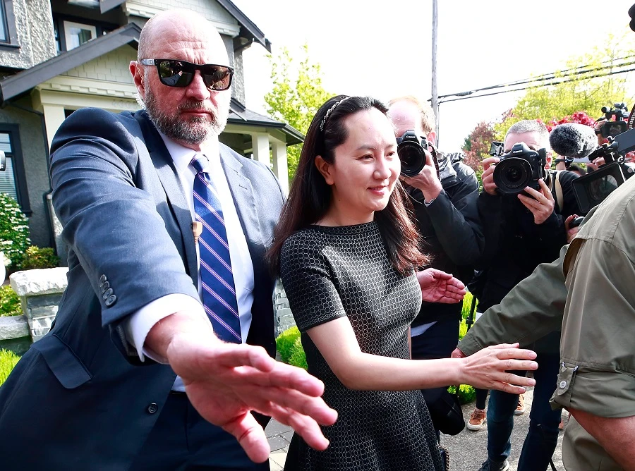 Huawei Technologies Chief Financial Officer Meng Wanzhou is escorted by security as she leaves her home on May 8, 2019 in Vancouver. (File/AFP)