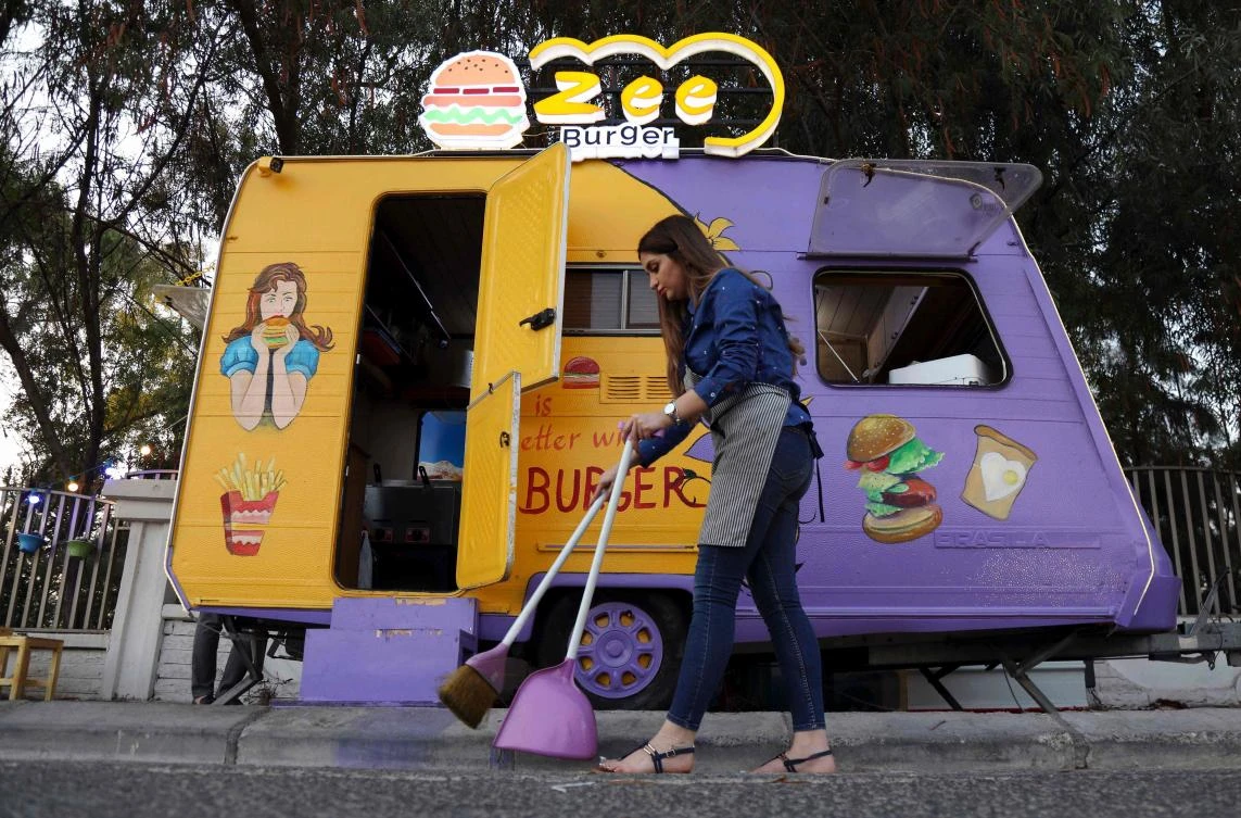 Kurdish entrepreneur Zilan Serwud launched Zee Burger in the regional capital Irbil, offering no-fuss fare of burgers, fries and onion rings served at small wooden tables. (AFP)