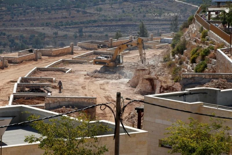 A labourer walks near a construction vehicle in the West Bank Jewish settlement of Shilo, near Ramallah October 6, 2016. (Reuters)