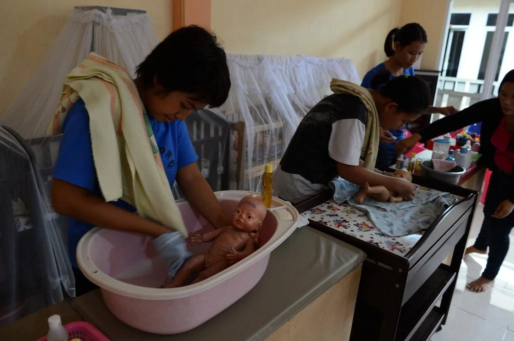 About 250,000 domestic helpers from other parts of Asia work in affluent Singapore. Above, Indonesian maids undergo training in Jakarta for infant care prior to their deployment. (AFP)