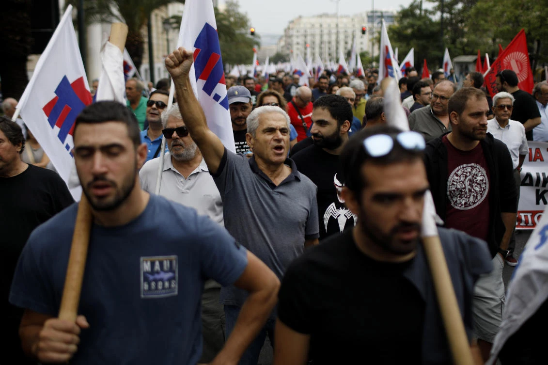 Protesters from Communist-affiliated PAME labor union hold flags and shout slogans during a 24-hour strike in central Athens, Tuesday, Sept. 24, 2019. (AP)