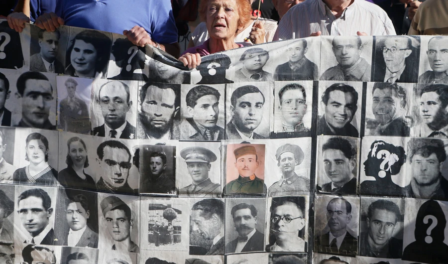 Protesters hold a banner showing photos of Spanish Civil War victims, outside the Supreme Court in Madrid, Spain, Tuesday, Sept. 24, 2019.(AP)