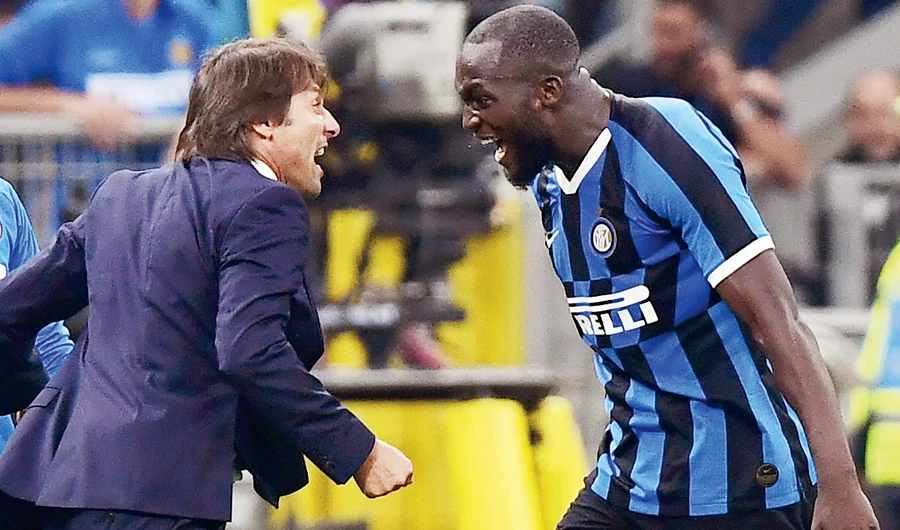 Inter Milan's Belgian forward Romelu Lukaku, right celebrates with Italian head coach Antonio Conte after scoring during the match against AC Milan on Saturday. (AFP/File)