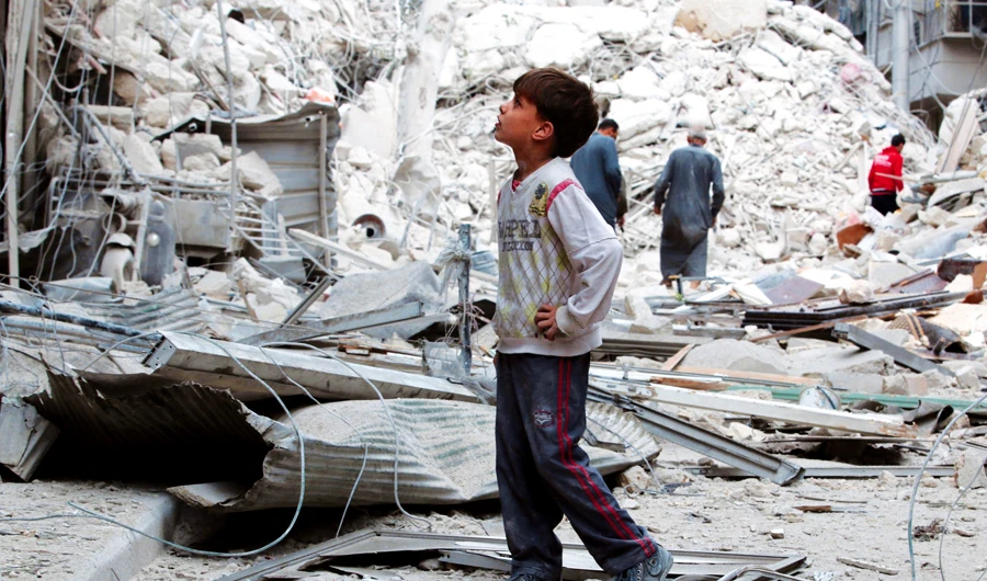 A boy inspects a damaged site after airstrikes in the Tariq Al-Bab neighborhood of Aleppo, Syria. (Reuters)