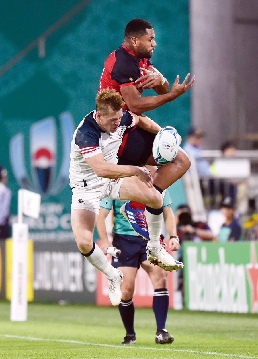England's Joe Cokanasiga in action with Will Hooley of the US during their match on Thursday. (Reuters)