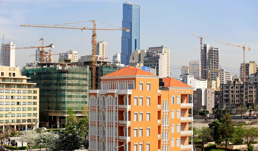 This April 2, 2018 photo, an old building with a traditional red brick roof, foreground, is overshadowed by newer, taller modern buildings, some still under construction, in Beirut, Lebanon. (AP)