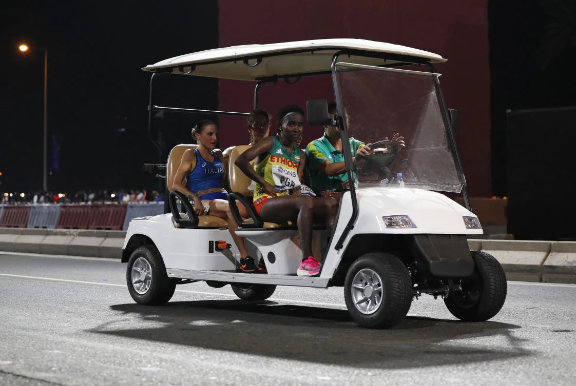 Runners sit in a golf cart after abandoning the women’s marathon at the World Athletics Championships in Doha, Qatar on Saturday, Sept. 28, 2019. (AP)