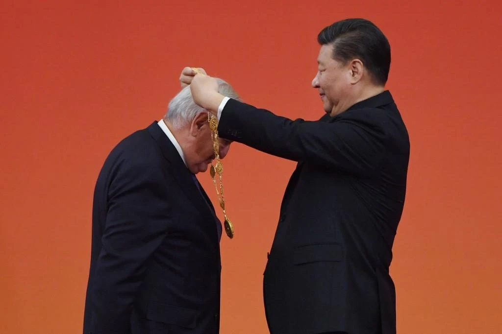 Chinese President Xi Jinping awarded former French PM Jean-Pierre Raffarin for his “long-term commitment to promoting China-France friendship.” (AFP)