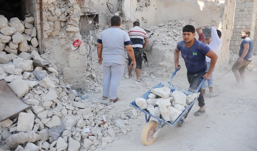 Workers take part in restorations of the old Aleppo market. (AFP)