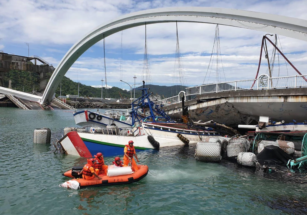 The collapse of the bridge damaged three fishing boats and two vehicles, Taiwan officials said. (Taiwan’s Coast Guard via AP)