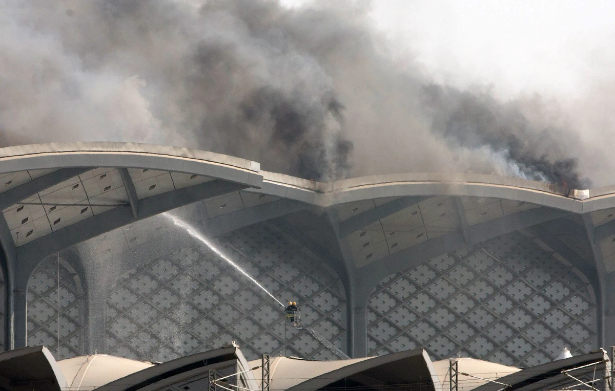 Saudi Civil Defense firefighters put out a fire that broke out at the Haramain high-speed train station in Jeddah. (AFP)