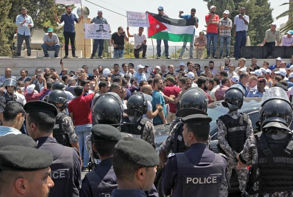 Jordanian teachers display their national flag during a protest in the capital Amman. (File/AFP)