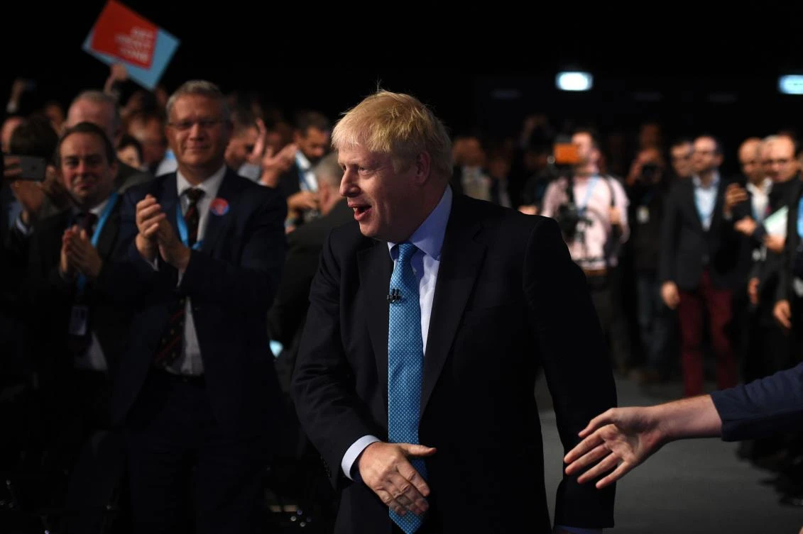TOPSHOT - Britain's Prime Minister Boris Johnson attends the final day of the annual Conservative Party conference at the Manchester Central convention complex, in Manchester, north-west England on October 2, 2019. Prime Minister Boris Johnson was set to unveil his plan for a new Brexit deal at his Conservative party conference Wednesday, warning the EU it is that or Britain leaves with no agreement this month. Downing Street said Johnson would give details of a "fair and reasonable compromise" in his closing address to the gathering in Manchester, and would table the plans in Brussels the same day. / AFP / Oli SCARFF