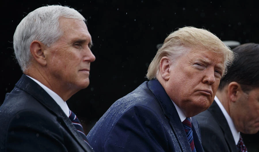 In this Sept. 30, 2019 photo, Vice President Mike Pence and President Donald Trump participate in an Armed Forces welcome ceremony for the new chairman of the Joint Chiefs of Staff, Gen. Mark Milley, at Joint Base Myer-Henderson Hall, Virginia. (AP Photo/Evan Vucci)