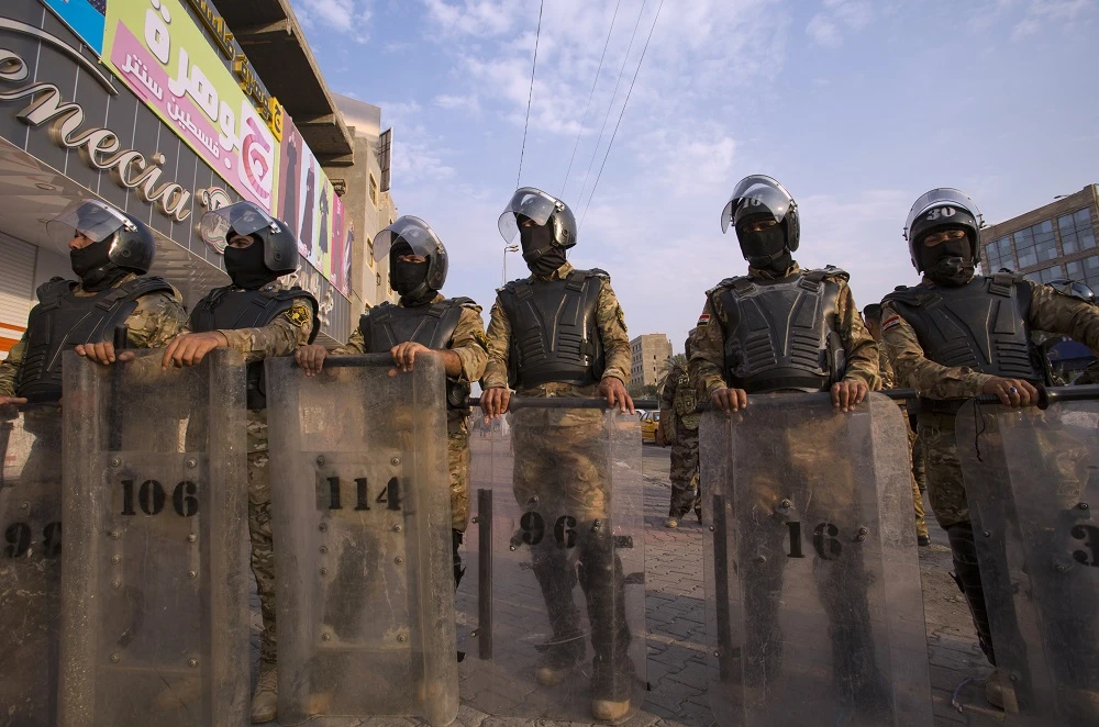 Iraqi riot police stand guard as protestors take part in a demonstration against state corruption, failing public services and unemployment, on October 2, 2019 in the southern city of Basra. (File/AFP)