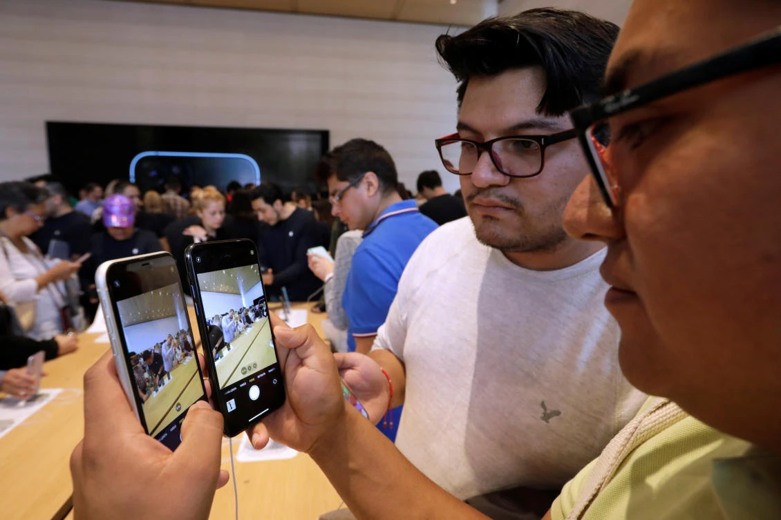 Customers test the new iPhone 11 during the opening of Mexico’s first flagship Apple store in Mexico City, Mexico in this September 27, 2019 file photo. (Reuters)