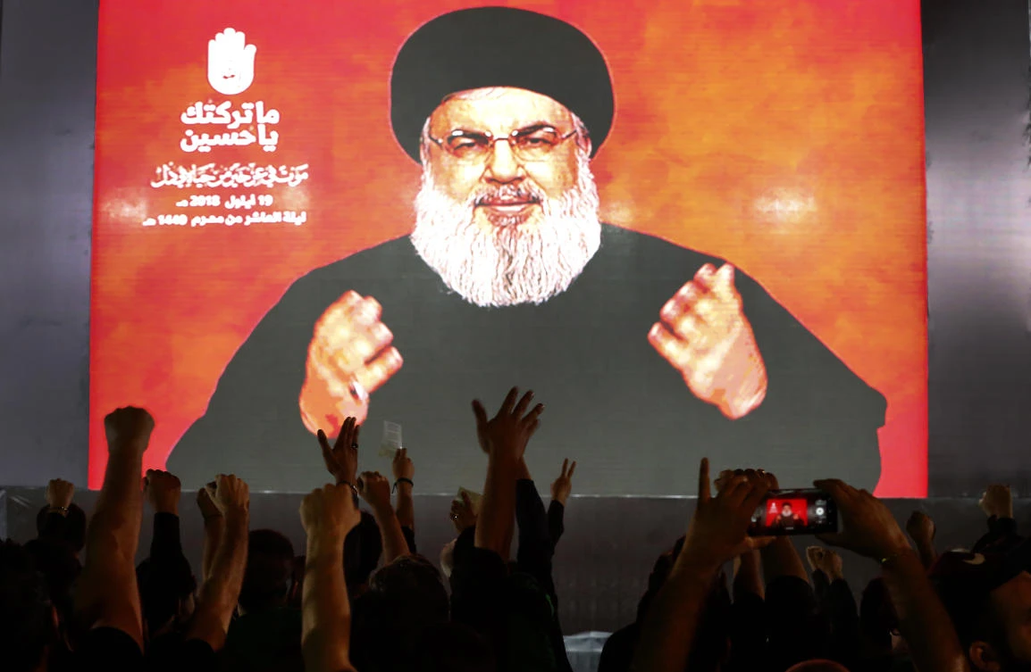 Hezbollah leader Sheik Hassan Nasrallah speaks via a video link, during activities commemorating the death of Imam Hussein, in a southern suburb of Beirut, Lebanon. (File/AP/Hussein Malla)