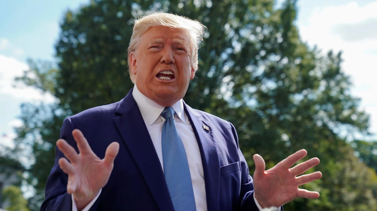 US President Donald Trump responds to reporters questions as he heads to the Marine One helicopter to fly to visit injured members of the US military at Walter Reed National Military Medical Center in Maryland from the White House in Washington, October 4, 2019. (Reuters)