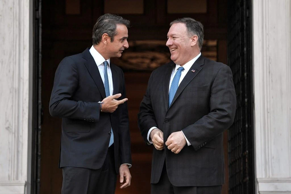 Greek PM, left, told US Secretary of State Mike Pompeo, right, that Turkey’s drilling actions are a violation of sovereignty rights. (AFP)