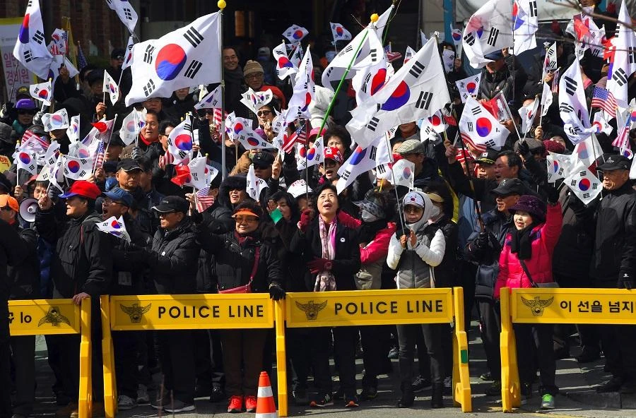 Pro-government activists wave national flags during a rally opposing impeachment of South Korea's President Park Geun-Hye near the Constitutional Court in Seoul on March 9, 2017. (File/AFP)