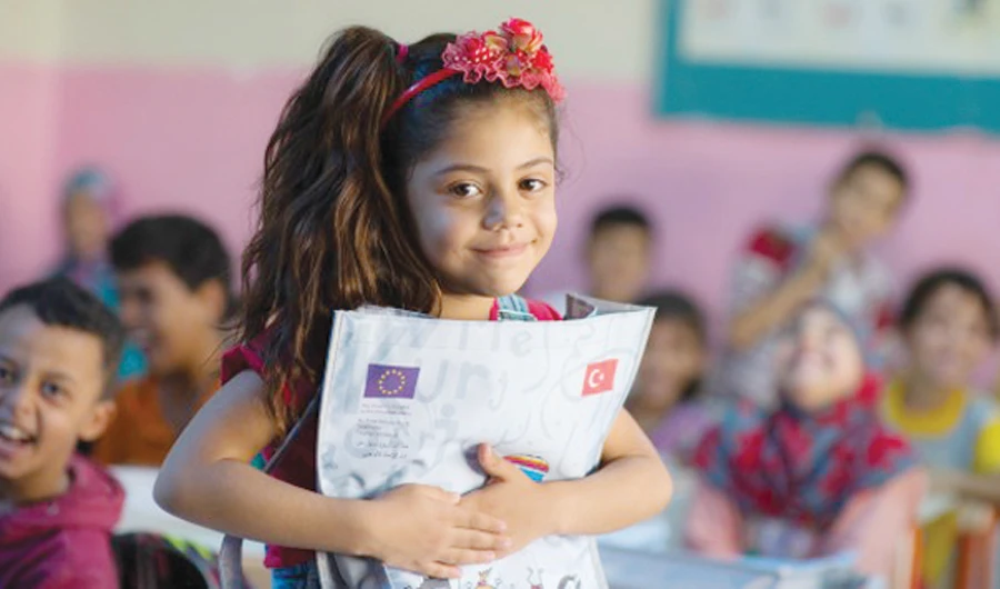 A Syrian girl poses in a school run by UNICEF in a refugee camp in Sanliurfa, Turkey.