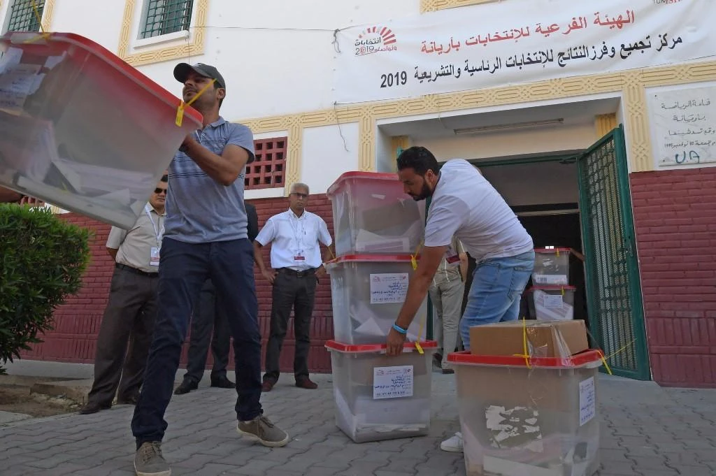 Independent High Authority for Elections staff dispatch ballot boxes to polling stations in Tunis on Saturday, October 5, 2019. (AFP)