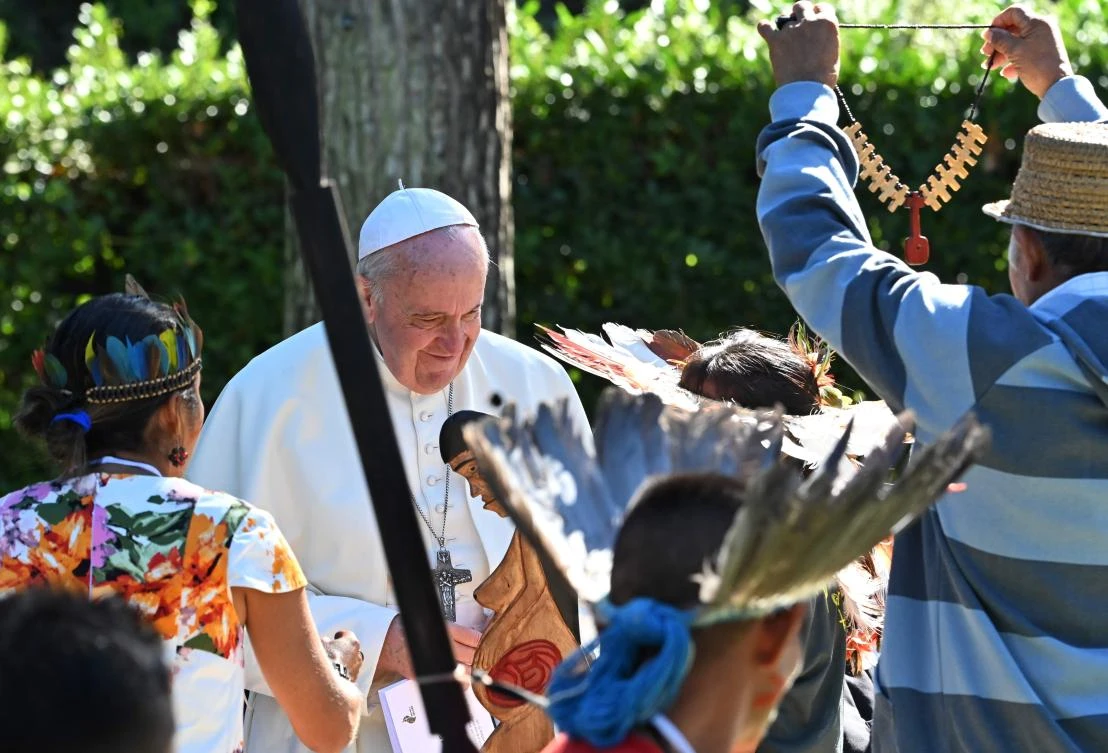 Pope Francis receives gifts from representatives of indigenous communities of the Amazon on October 4, 2019 in the Vatican gardens before the Amazon synod that takes place on October 6, 2019. (File/AFP)