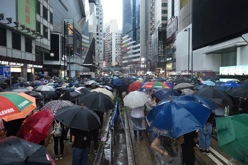 People gather for a rainy protest march in the Causeway Bay shopping district of Hong Kong on Sunday, October 6, 2019. (AFP)