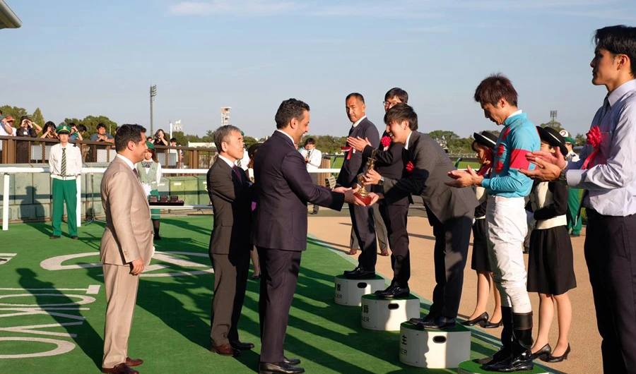 Equestrian Club General Manager Adel Al-Mazroua awards the Saudi cup to Al-Ishibashi Shuo, jockey of the winning horse Sirus. (Photo/Supplied)