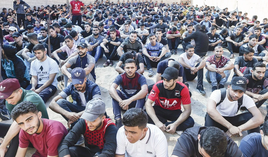 Palestinian men wait at a police training center in Gaza City to undergo a physical fitness examination for police jobs. (AFP)