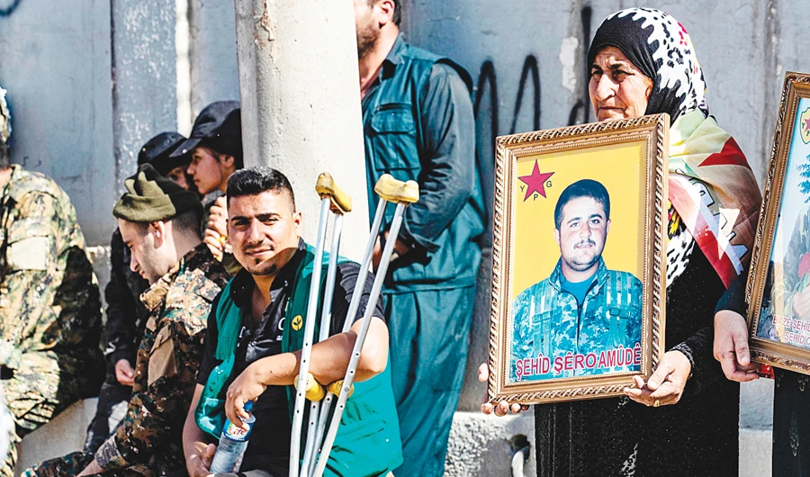 Kurdish fighters and veterans protest against Turkish threats in Qamishli. (AFP)