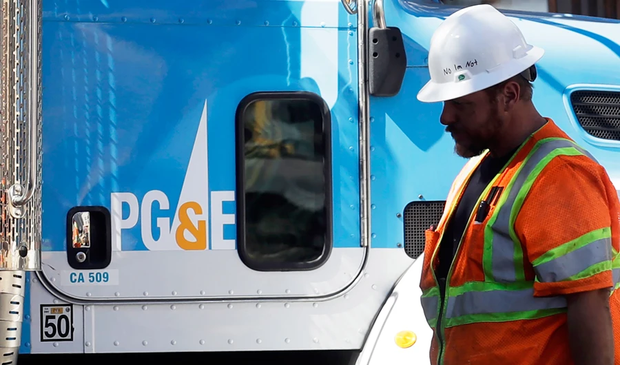 In this Aug. 15, 2019, file photo, a Pacific Gas & Electric worker walks in front of a truck in San Francisco. (AP)