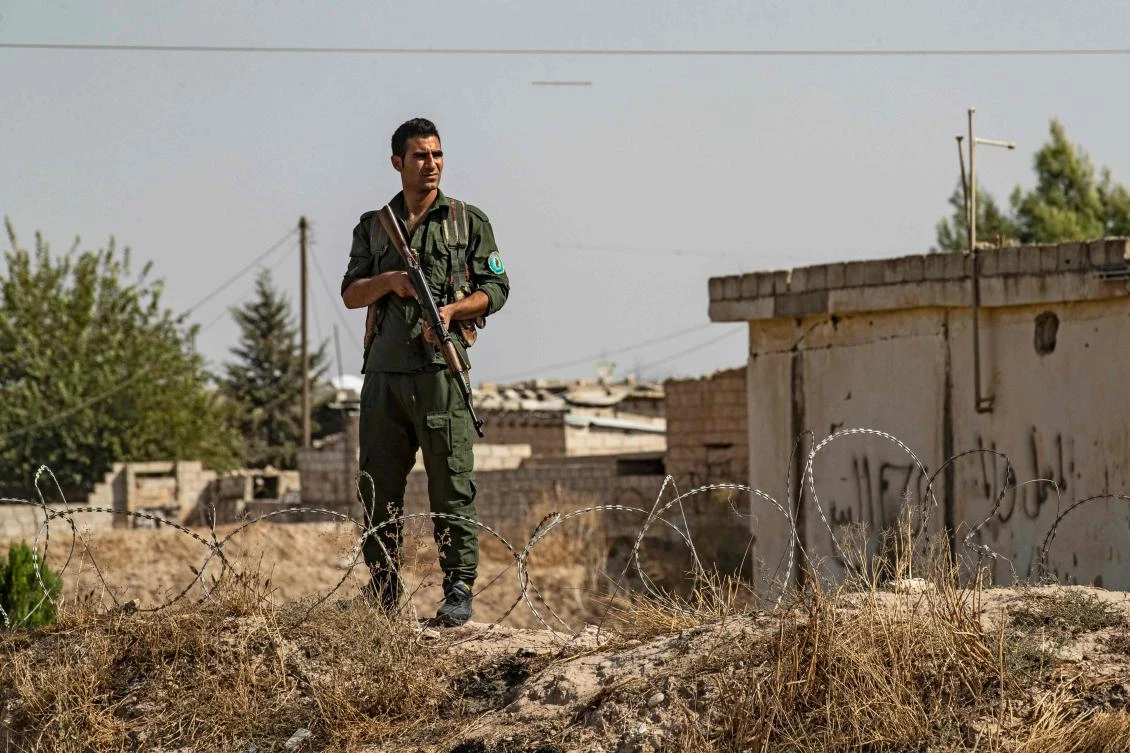 A member of the Kurdish Internal Security Forces of Asayesh stands guard during a demonstration by Syrian Kurds against Turkish threats in the town of Ras al-Ain in Syria's Hasakeh province near the Turkish border on October 6, 2019. (File/AFP)