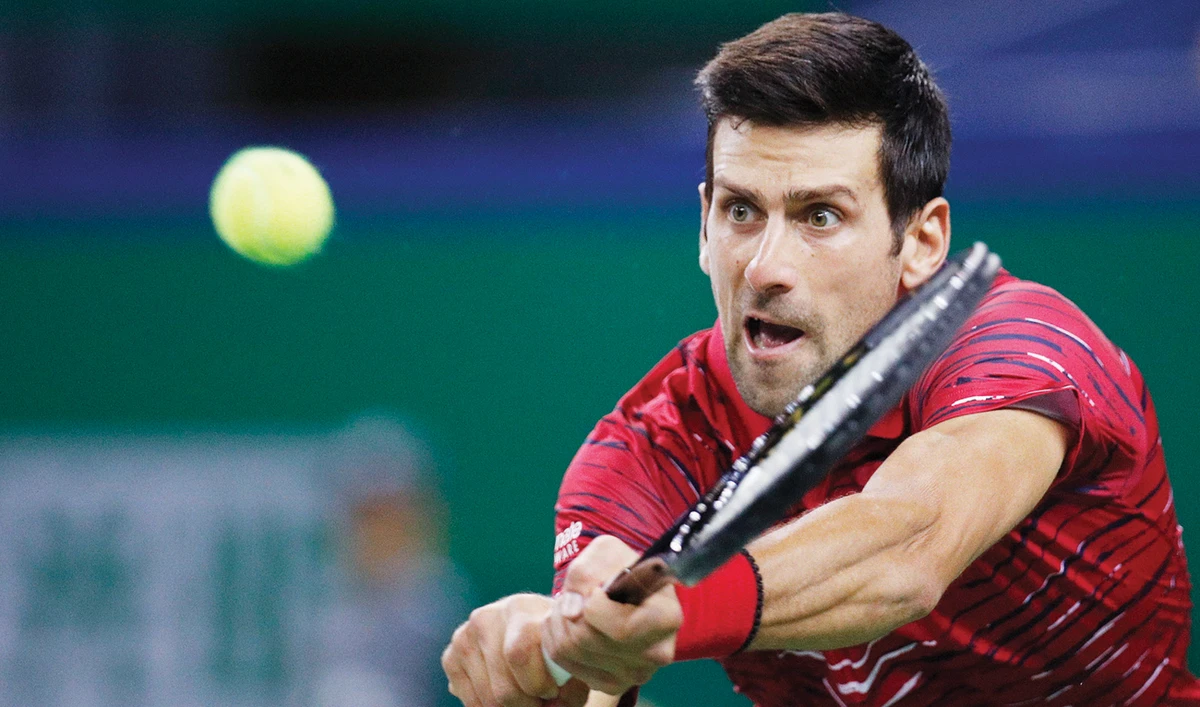 Novak Djokovic hits a return shot against Denis Shapovalov of Canada. (AP )