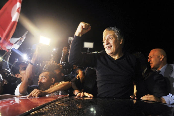 Tunisian presidential candidate and media mogul Nabil Karoui, waves as he is greeted by jubilant crowds after he was released from prison in Mannouba, Tunisia, on Oct. 9, 2019, just four days before the upcoming presidential runoff election. (AP Photo)