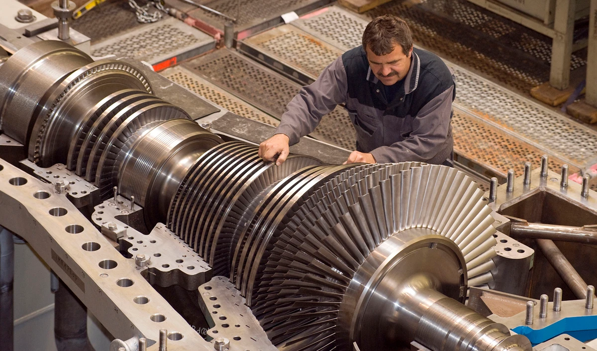 An employee of MAN Turbo company works on compressors and turbines at the factory in Oberhausen, western Germany. (File/AP)