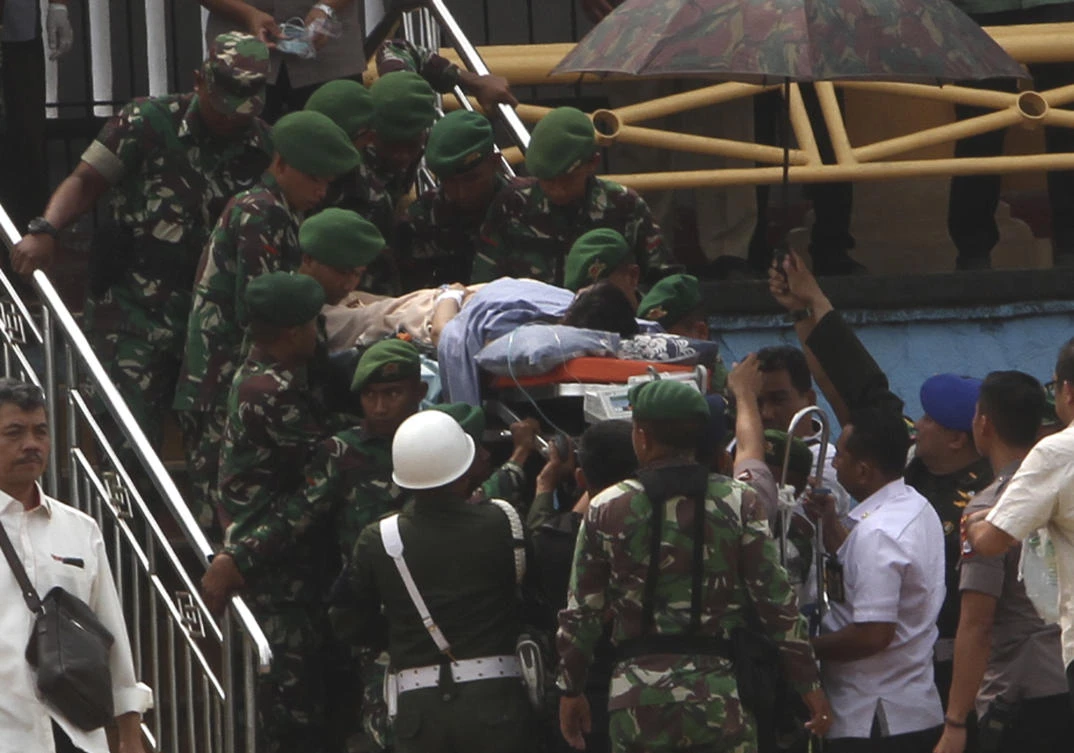 Soldiers carry Indonesian chief security minister Wiranto on a stretcher to a waiting helicopter to be evacuated to Jakarta on Thursday, Oct. 10, 2019. (AP)