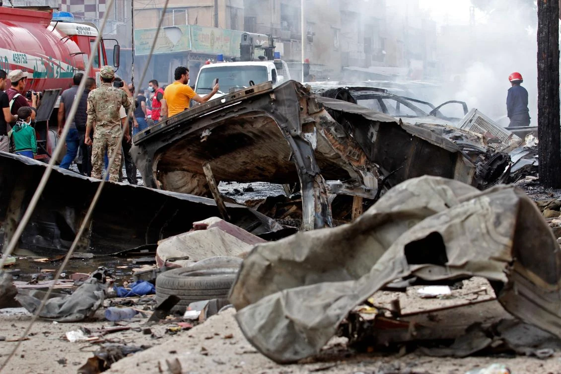 People gather at the site of an explosion in the northeastern Syrian Kurdish city of Qamishli on October 11, 2019. (AFP/Mohammed Ahmad)