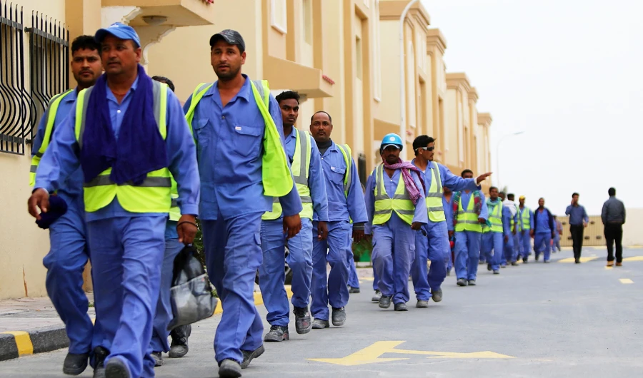 This file photo taken on May 4, 2015 shows foreign laborers working on the construction site of the al-Wakrah football stadium walking back to their accomodation in Doha's Al-Wakrah southern suburbs. (AFP)