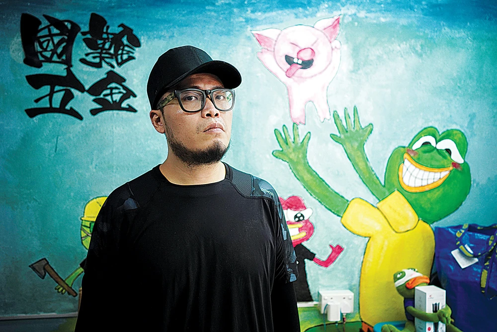 Keita Lee, owner of the “National Calamity Hardware Store,” poses at his shop in Hong Kong. (Reuters)