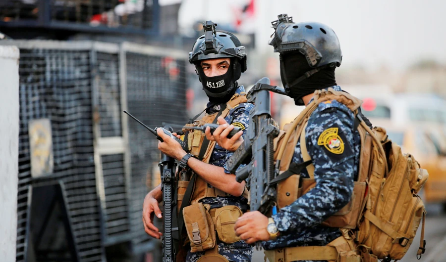 Members of Iraqi federal police are seen with military vehicles in a street in Baghdad, Iraq October 7, 2019. (Reuters)